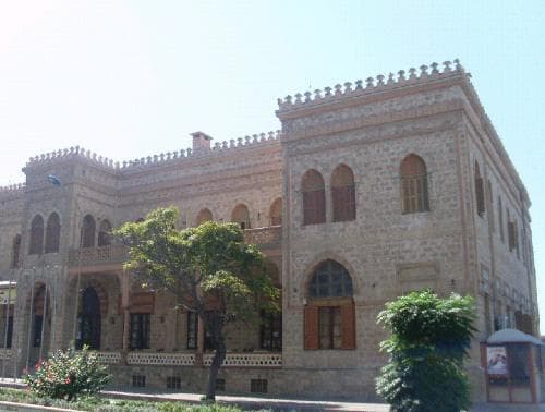 ASSAS Group, Syria. Latakia Casino, restoration and hotel conversion: Exterior view of the historic stone building, showing arched windows and decorative parapets.